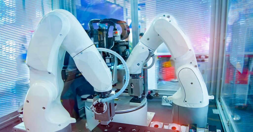 Robotic arms automating the manufacturing in a smart industry.