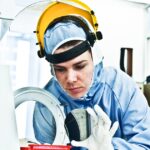 Female Scientist Working on Silicon Wafer Fabrication in Cleanroom in Semiconductor fab