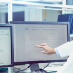 Scientist Interacting With The Computer Via Touch Screen