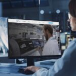 Woman looking at "Making Industry 4.0 a Reality" article of Critical Manufacturing, in a Electronics lab.
