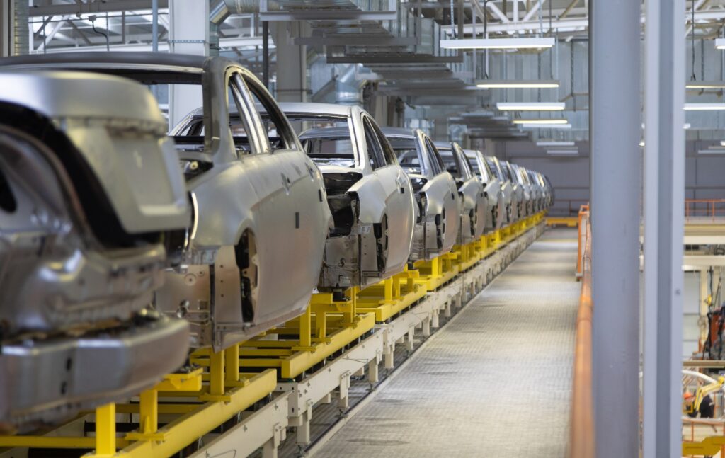body of car on conveyor Modern Assembly of cars at plant. automated build process of automotive production