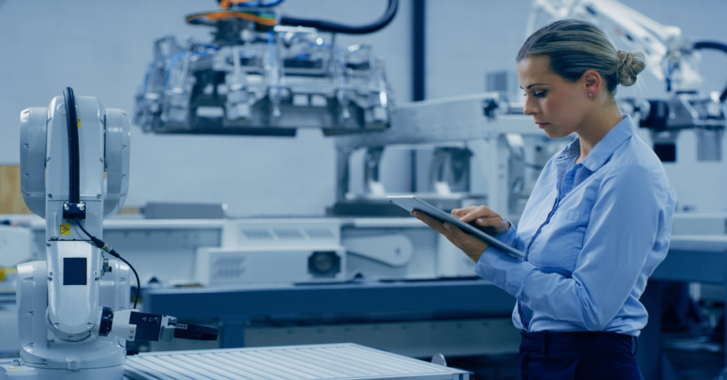 Worker holding a tablet in a smart manufacturing environment